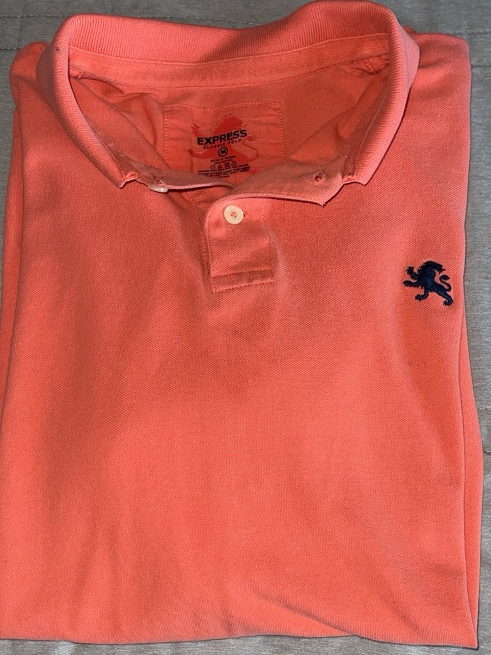 Express Men’s Coral-Orange Polo with Navy Lion Emblem